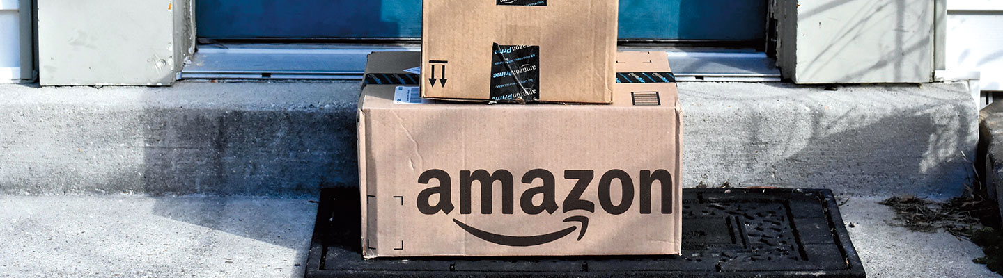 Amazon boxes stacked on a doorstep