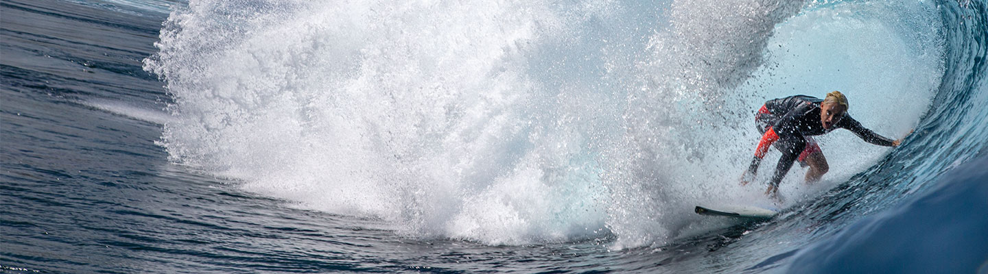 Photo of a surfer going through a wave